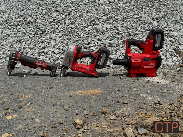 Good Times Plumbing's Milwaukee press and drain tools lined up on a job site