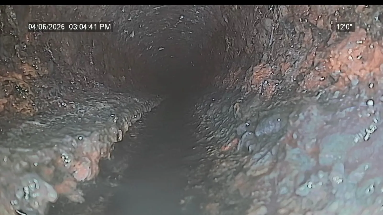 Sewer camera view of a corroded, failing sewer line before trenchless repair